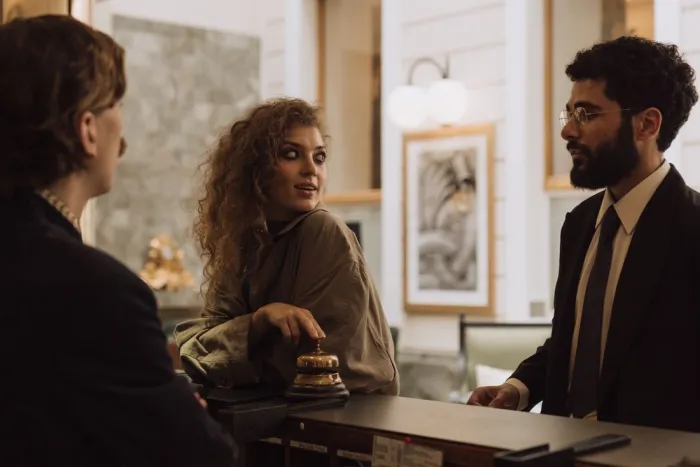 A hotel receptionist helping guests at the front desk